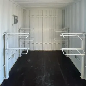 shipping container interior with storage shelving and dark flooring